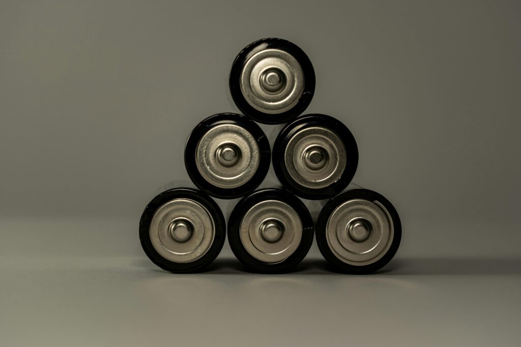Metallic AA batteries stacked in a pyramid shape, symbolizing power and energy storage.